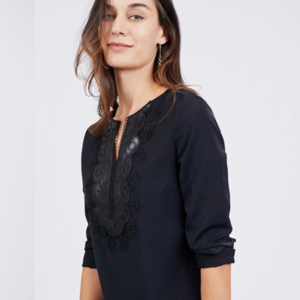 Small black long sleeve blouse with intricate leather detail around neck.